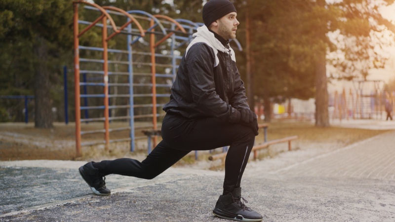 Attractive man runner doing stretching exercise