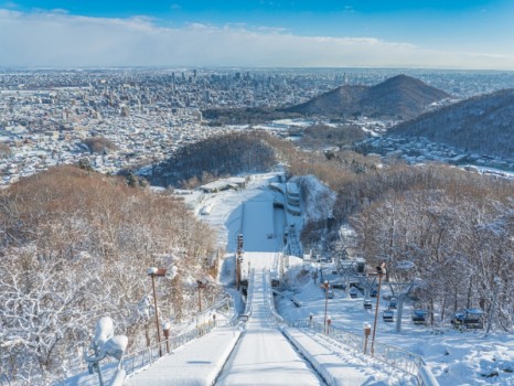 Panorama of Sapporo city from Okurayama Ski Jump in the Sunny Day and blue sky in winter at Sapporo, Hokkaido, Japan