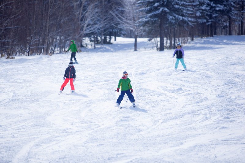 ゲレンデでスキーを楽しむ子どもたち
